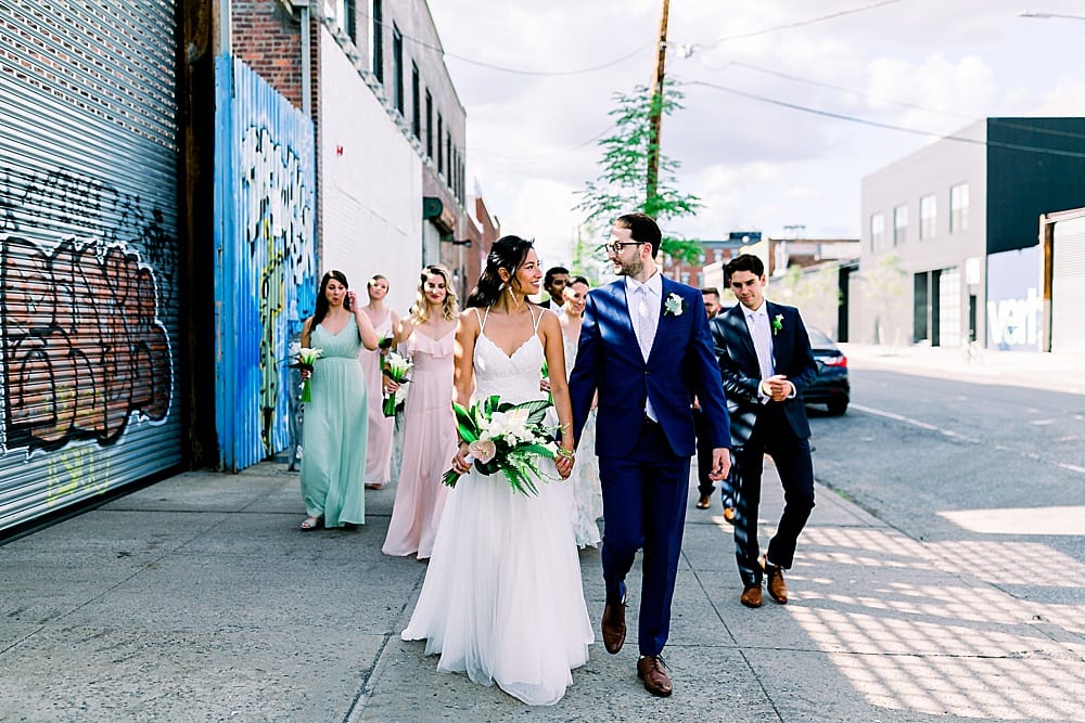 bride and groom walking with bridal party
