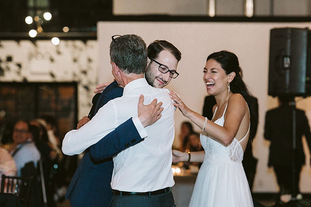 groom hugging father of the bride